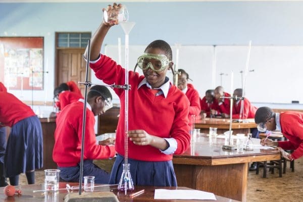 Girl Filling Test Tube in Science Class at Orkeeswa