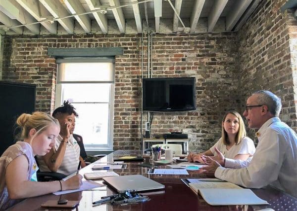 Group of Co-Workers Discussing at Conference Table